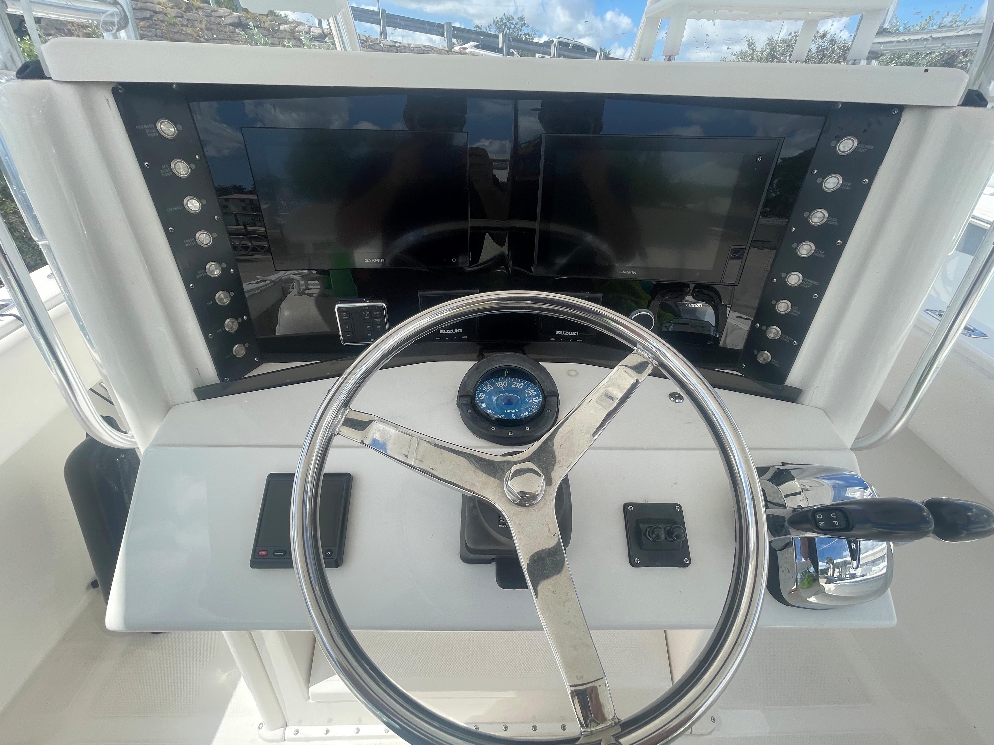 Steering console of a 2004 Venture 34 Open boat with modern controls and displays.