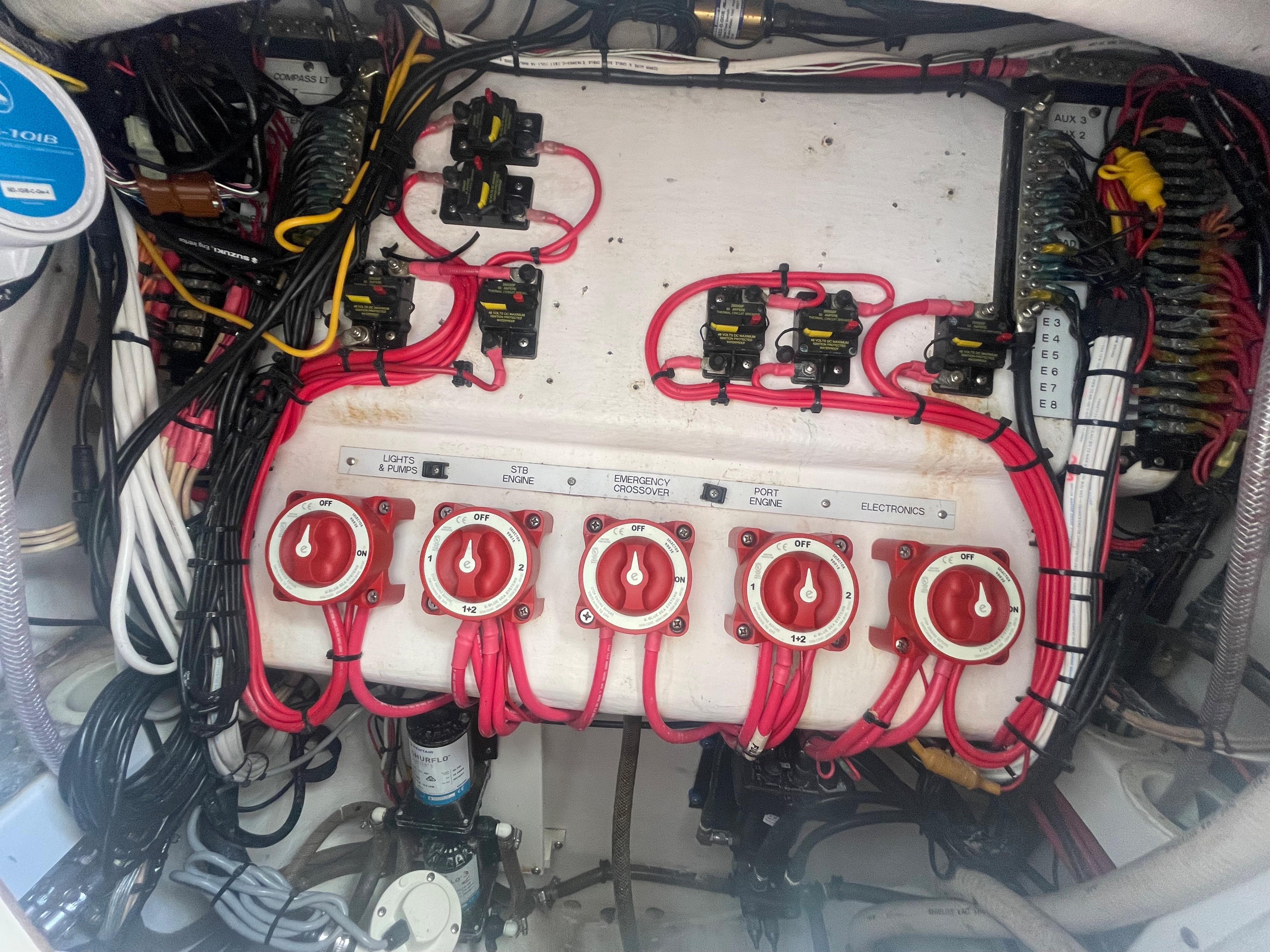 Electrical panel with red cables in a 2004 Venture 34 Open boat.