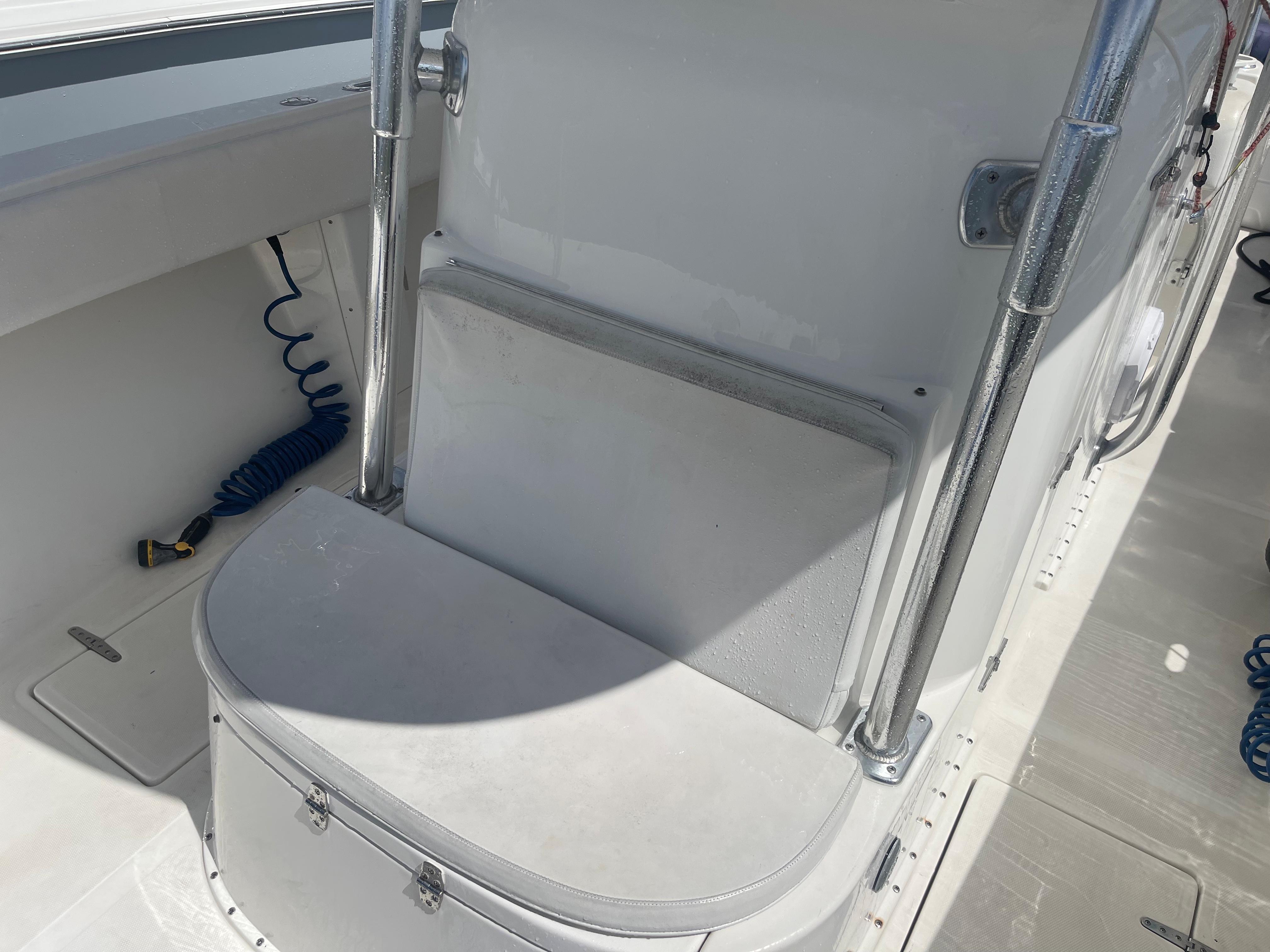 2004 Venture 34 Open boat interior with seating and storage compartment.