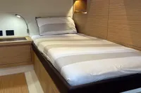 2020 Pardo Yachts 43 interior cabin with modern wood finish and cozy bed.
