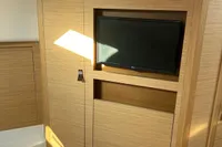 Interior of 2020 Pardo Yachts 43 with built-in TV and wooden paneling.