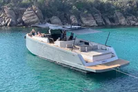 2020 Pardo Yachts 43 in turquoise waters near rocky shoreline.