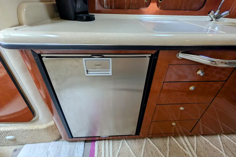  Yacht Photos Pics 2004 Sea Ray 340 Sundancer interior with Dometic fridge and wooden cabinetry.