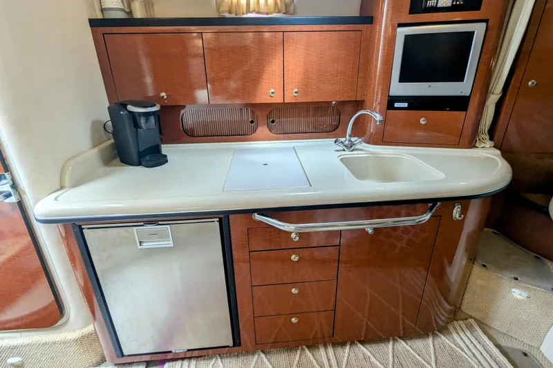  Yacht Photos Pics 2004 Sea Ray 340 Sundancer galley with sink, cabinets, and coffee maker.