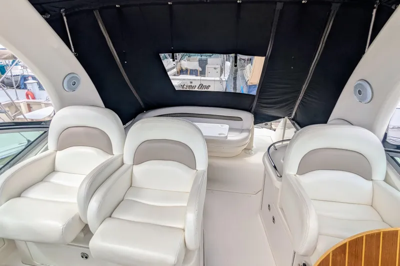  Yacht Photos Pics Interior of 2004 Sea Ray 340 Sundancer with white seating and black canopy.