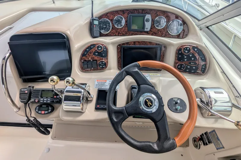  Yacht Photos Pics 2004 Sea Ray 340 Sundancer helm with steering wheel, controls, and navigation instruments.