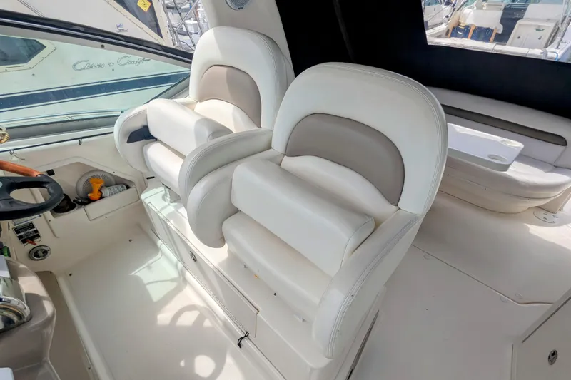  Yacht Photos Pics 2004 Sea Ray 340 Sundancer cockpit with plush white seating and steering wheel.