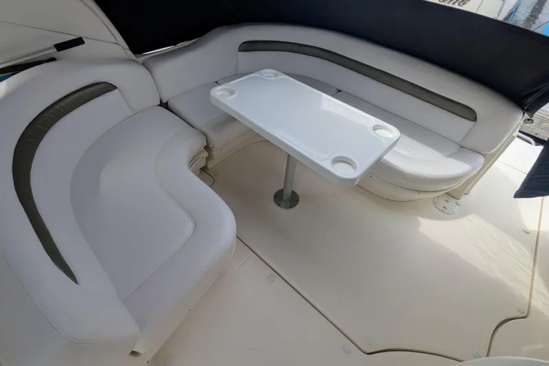  Yacht Photos Pics 2004 Sea Ray 340 Sundancer interior with white seating and table in the cockpit area.