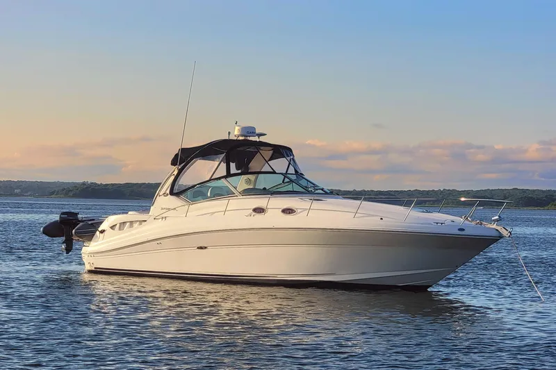 Yacht Photos Pics 2004 Sea Ray 340 Sundancer yacht on calm water at sunset.