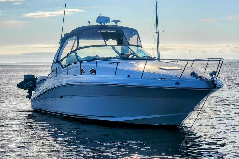  Yacht Photos Pics 2004 Sea Ray 340 Sundancer yacht on calm water at sunset.