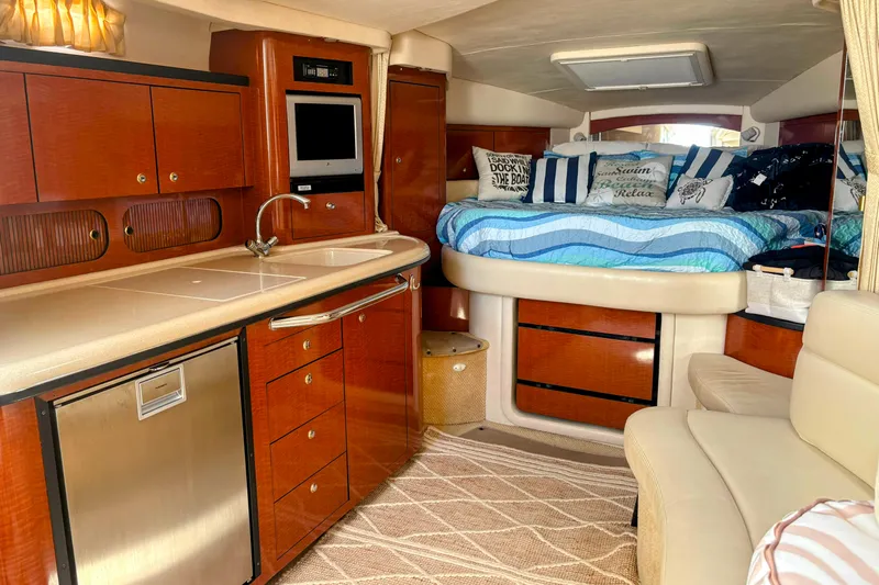  Yacht Photos Pics Luxurious 2004 Sea Ray 340 Sundancer cabin with kitchenette and cozy sleeping area.