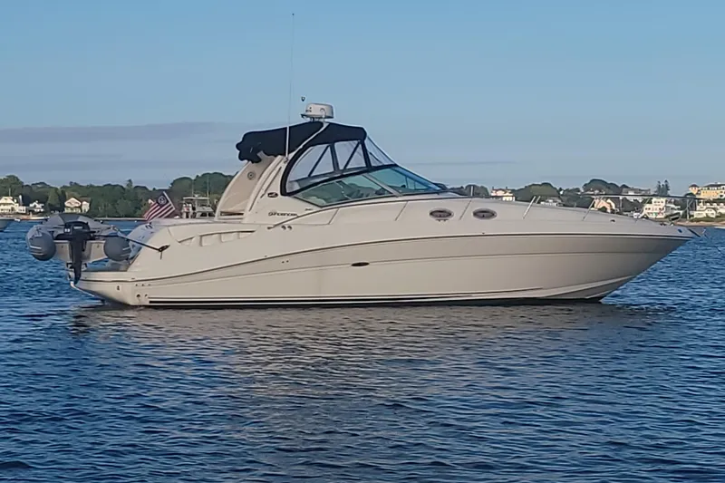  Yacht Photos Pics 2004 Sea Ray 340 Sundancer yacht on calm water, clear sky background.