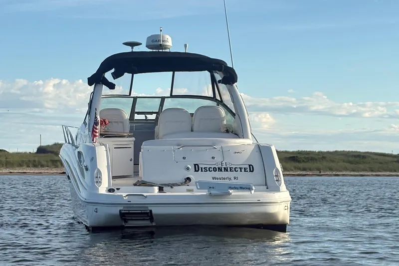  Yacht Photos Pics 2004 Sea Ray 340 Sundancer boat on water, rear view, clear sky background.