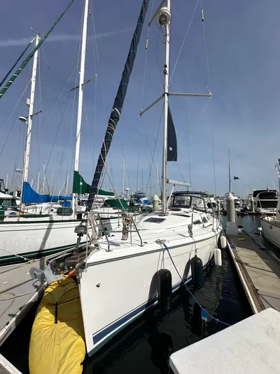  Yacht Photos Pics 2008 Hunter 38 sailboat docked at marina, surrounded by other boats.