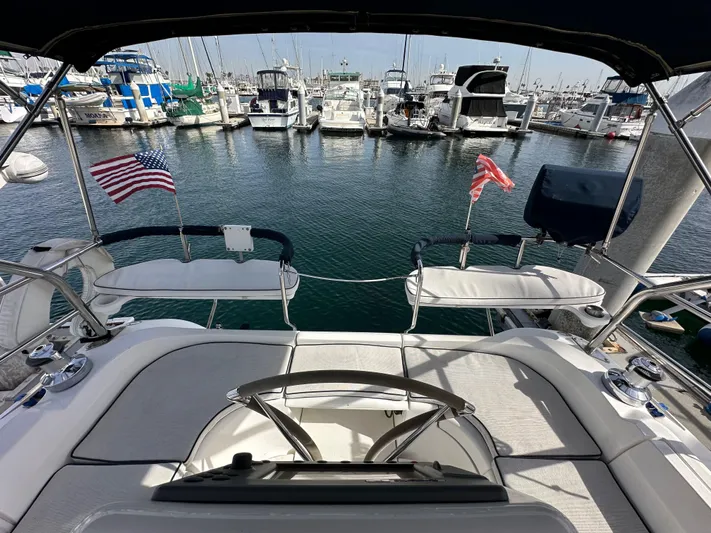  Yacht Photos Pics Hunter 38 sailboat cockpit, 2008 model, docked at marina with American flags.