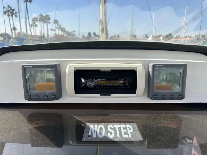  Yacht Photos Pics Control panel of a 2008 Hunter 38 sailboat with navigation displays and "No Step" sign.