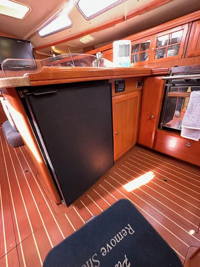  Yacht Photos Pics Interior of 2008 Hunter 38 sailboat kitchen with wood cabinetry and appliances.