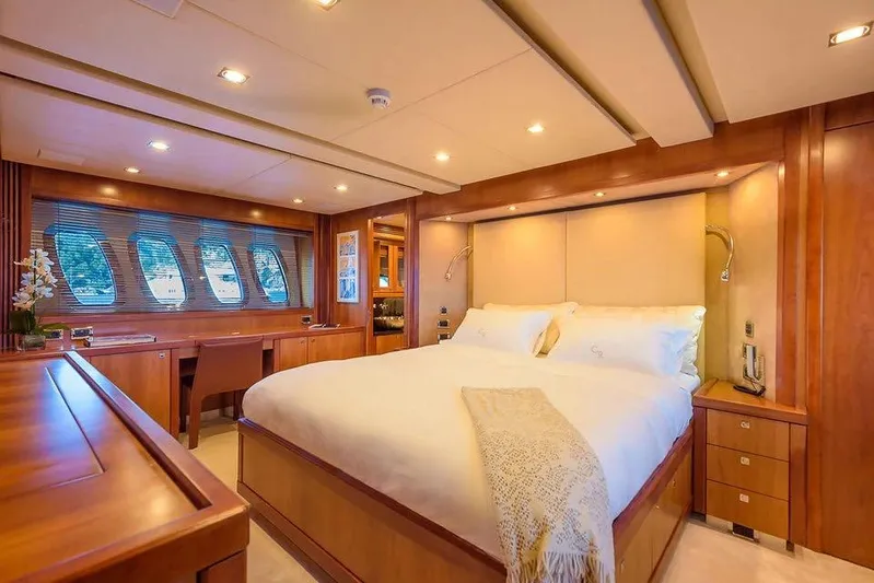  Yacht Photos Pics Luxurious bedroom interior on 2010 Sunseeker Predator 108 yacht, featuring elegant wood finishes.