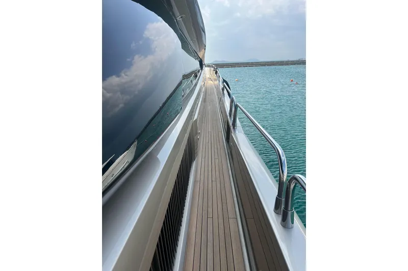  Yacht Photos Pics Side view of 2010 Sunseeker Predator 108 yacht with sleek deck and ocean reflection.