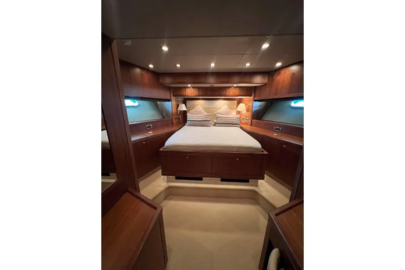  Yacht Photos Pics Luxurious bedroom interior of 2010 Sunseeker Predator 108 yacht with elegant wood finish.