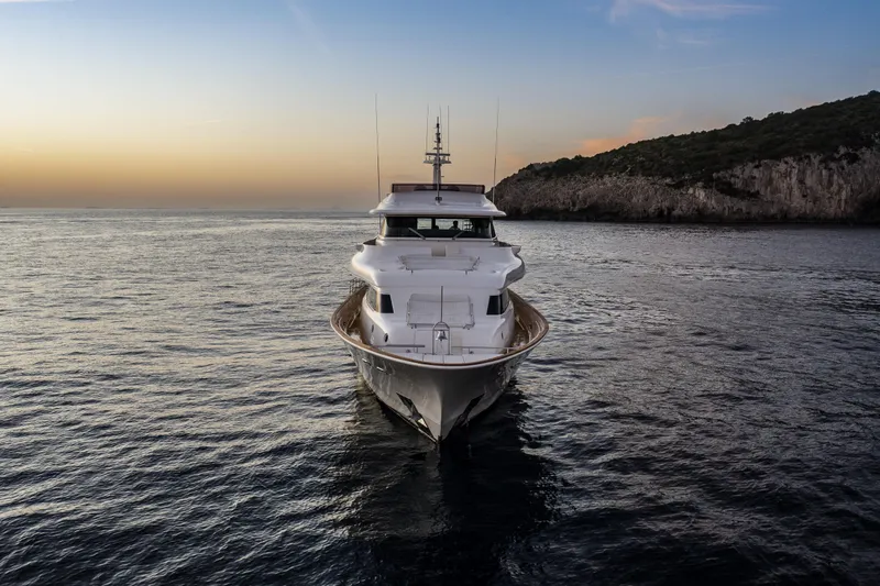  Yacht Photos Pics Luxurious 2013 Custom Line Navetta 33 Crescendo yacht at sunset on serene waters.
