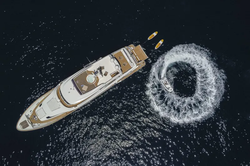  Yacht Photos Pics Aerial view of 2013 Custom Line Navetta 33 Crescendo yacht with a speedboat circling nearby.