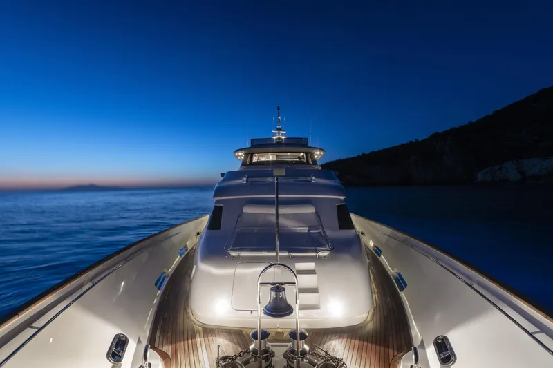  Yacht Photos Pics Luxurious 2013 Custom Line Navetta 33 Crescendo yacht at dusk on calm sea.