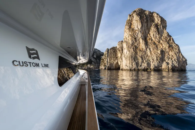  Yacht Photos Pics Custom Line Navetta 33 Crescendo yacht near rocky coastline, 2013 model.