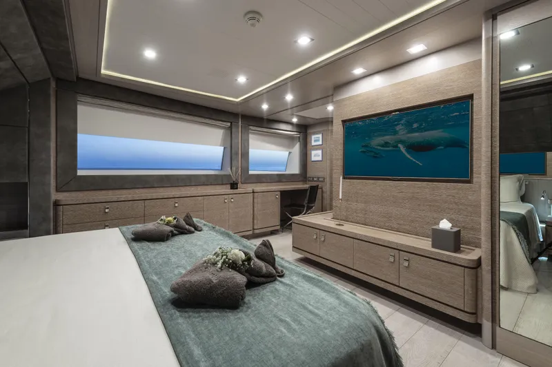 Yacht Photos Pics Luxurious bedroom interior on 2013 Custom Line Navetta 33 Crescendo yacht, featuring elegant decor and ocean view.