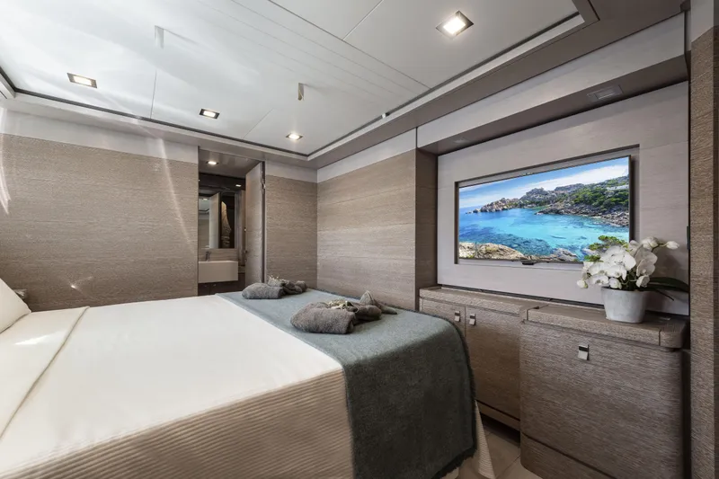  Yacht Photos Pics Luxurious bedroom interior on 2013 Custom Line Navetta 33 Crescendo yacht with TV and elegant decor.