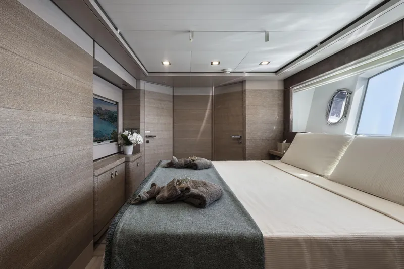  Yacht Photos Pics Luxurious bedroom interior on 2013 Custom Line Navetta 33 Crescendo yacht, featuring elegant wood paneling.