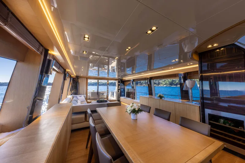 Mad Day Yacht Photos Pics Luxurious interior of 2018 Canados 888 Evolution yacht with elegant dining area and scenic ocean views.