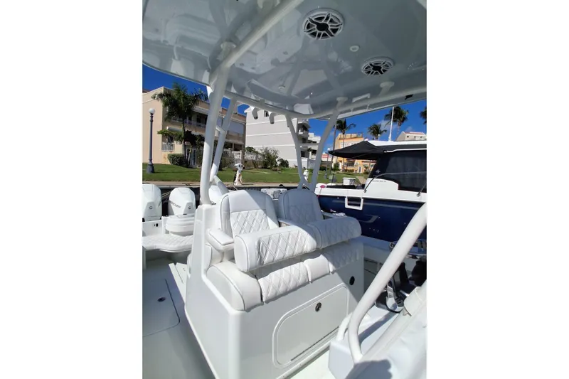 Testa Dura Yacht Photos Pics 2023 Yellowfin 36 Offshore boat interior with white seating and modern design.