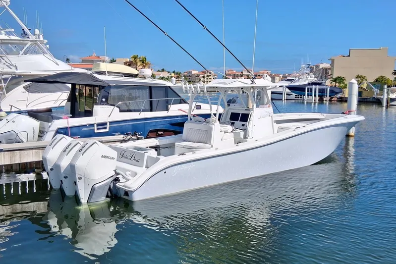 Testa Dura Yacht Photos Pics 2023 Yellowfin 36 Offshore boat docked in marina, featuring triple Mercury engines.