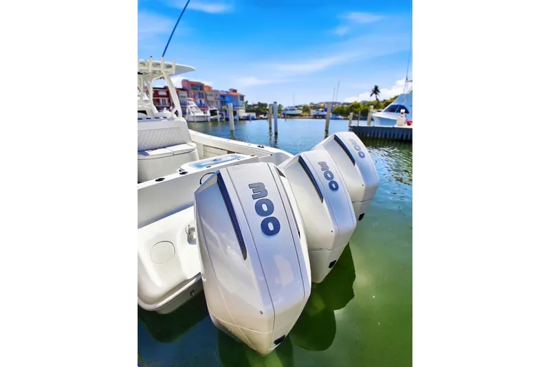 Testa Dura Yacht Photos Pics 2023 Yellowfin 36 Offshore boat with triple outboard engines docked in marina.