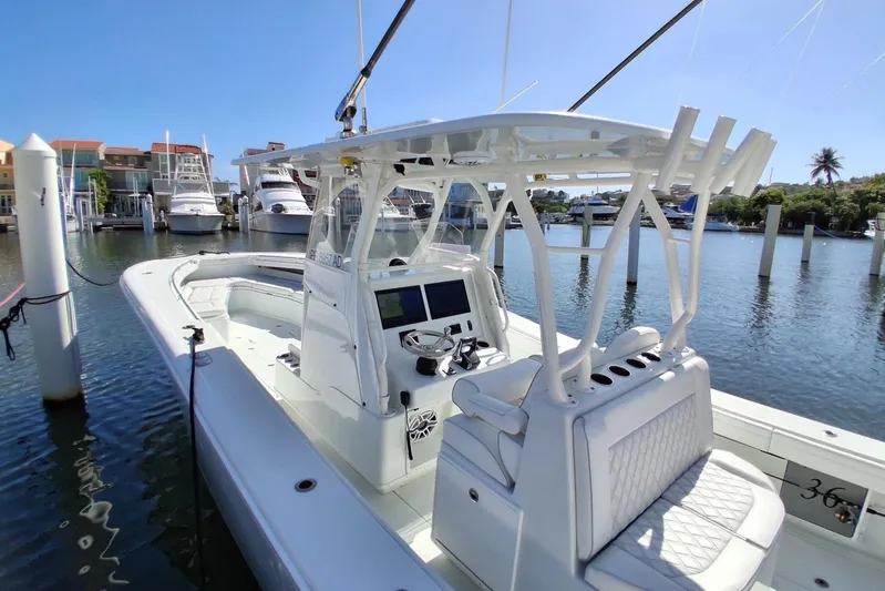 Testa Dura Yacht Photos Pics 2023 Yellowfin 36 Offshore boat docked in a marina under clear blue skies.