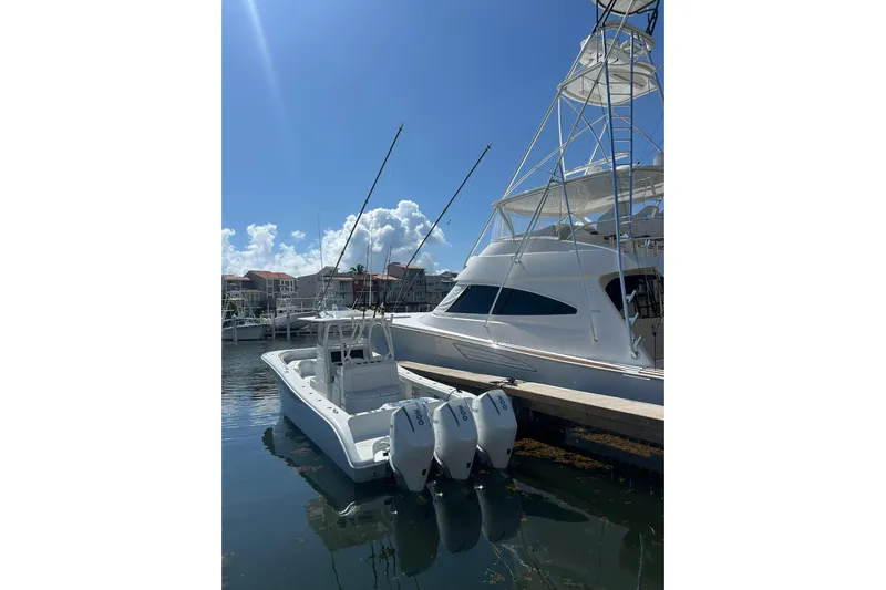 Testa Dura Yacht Photos Pics 2023 Yellowfin 36 Offshore boat docked with triple outboard engines.