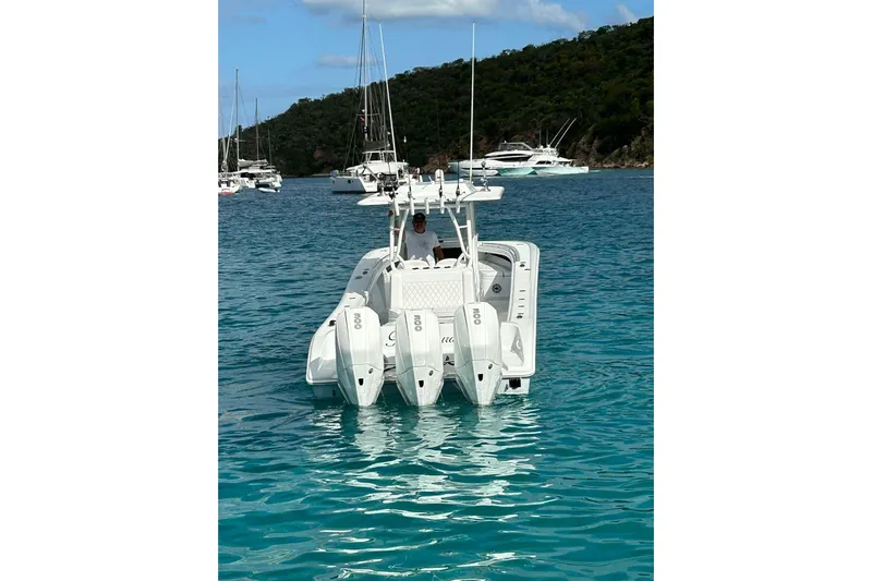 Testa Dura Yacht Photos Pics 2023 Yellowfin 36 Offshore boat with triple engines in clear blue water.
