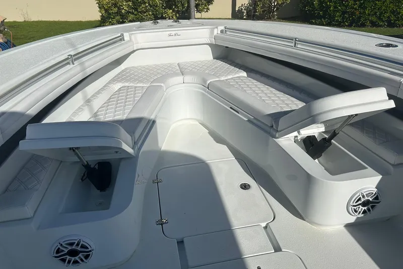 Testa Dura Yacht Photos Pics 2023 Yellowfin 36 Offshore boat interior with cushioned seating and storage compartments.