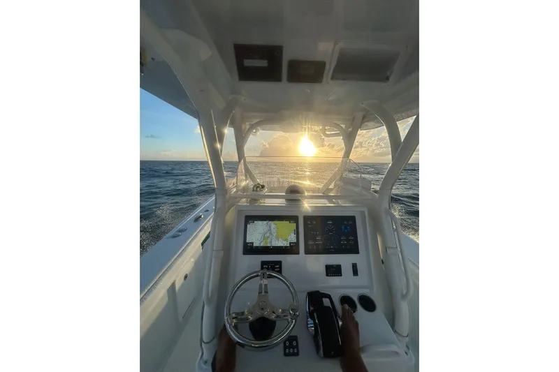 Testa Dura Yacht Photos Pics 2023 Yellowfin 36 Offshore boat dashboard with ocean sunset view.