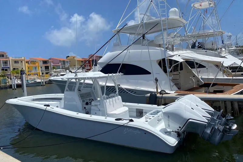 Testa Dura Yacht Photos Pics 2023 Yellowfin 36 Offshore boat docked at marina, clear sky background.