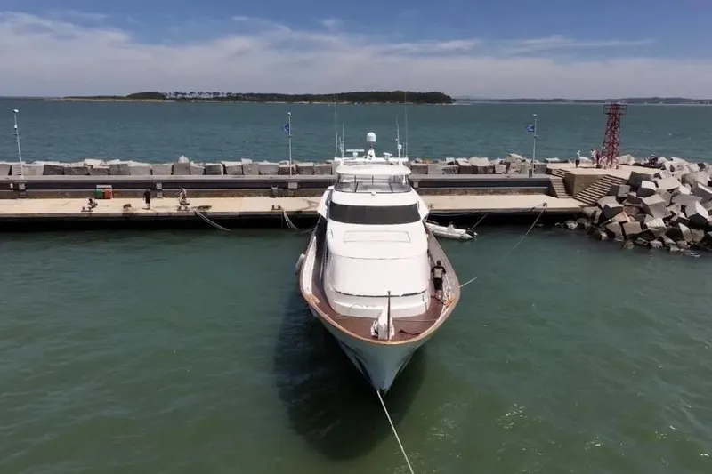  Yacht Photos Pics Luxury yacht Lurssen 110, 1987 model, docked at a scenic harbor.