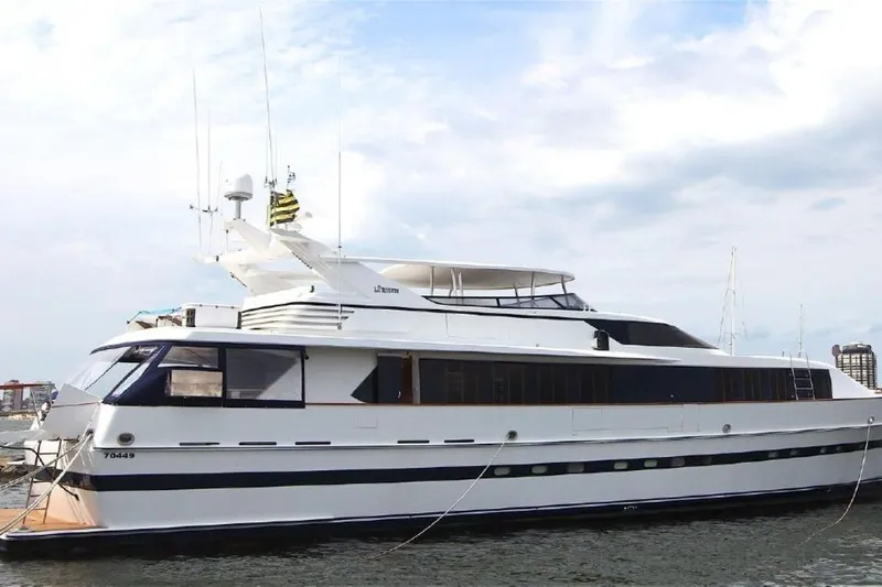  Yacht Photos Pics 1987 Lurssen 110 yacht docked, featuring sleek design and spacious upper deck.