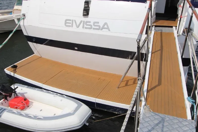  Yacht Photos Pics Stern view of 1987 Lurssen 110 yacht with tender and boarding ramp.