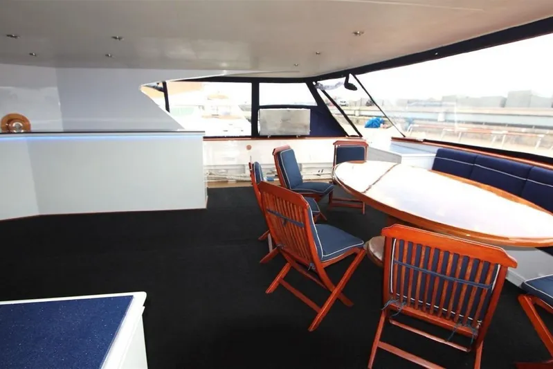  Yacht Photos Pics Luxurious interior of 1987 Lurssen 110 yacht with elegant dining area and panoramic windows.