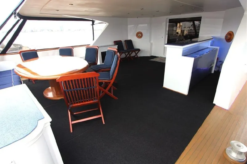  Yacht Photos Pics Luxurious 1987 Lurssen 110 yacht deck with dining area and seating.