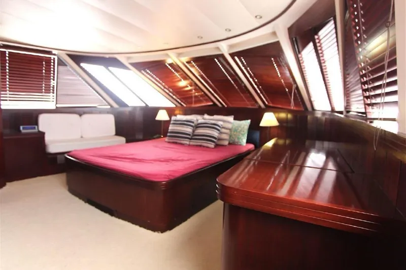  Yacht Photos Pics Luxurious cabin interior of 1987 Lurssen 110 yacht with elegant wood paneling.