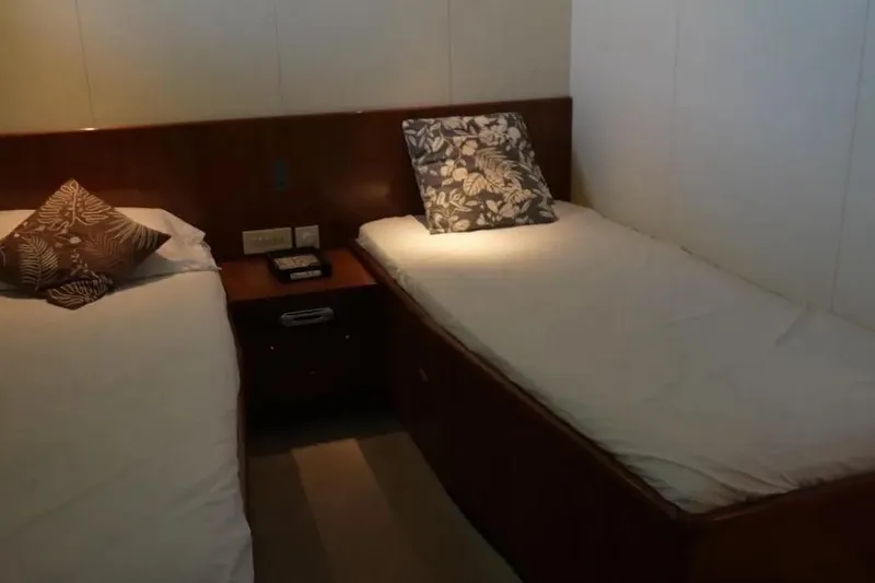  Yacht Photos Pics Twin beds in a 1987 Lurssen 110 yacht cabin with decorative pillows.
