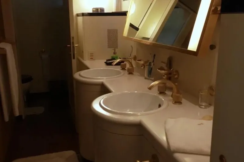  Yacht Photos Pics Luxurious bathroom with double sinks and gold fixtures on a 1987 Lurssen 110 yacht.