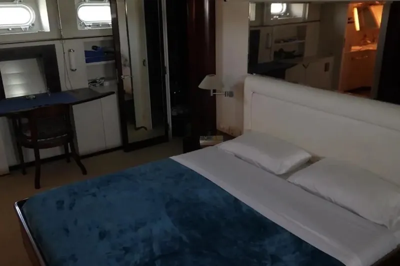  Yacht Photos Pics Luxurious bedroom interior on 1987 Lurssen 110 yacht, featuring elegant furnishings and natural light.